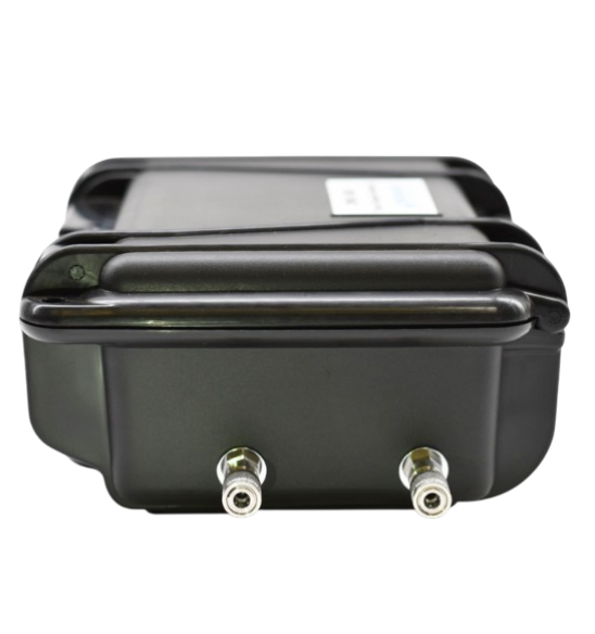 Side view of portable oxygen analyzer showing stainless steel compression fittings for gas inlet and outlet connections.