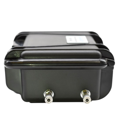Side view of portable oxygen analyzer showing stainless steel compression fittings for gas inlet and outlet connections.